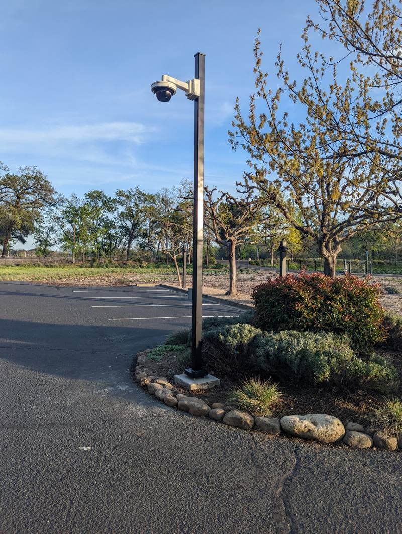 Outside light post with surveillance camera